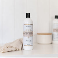 Bottle of Bon Savvy Linen Savvy on a white surface with a beige towel